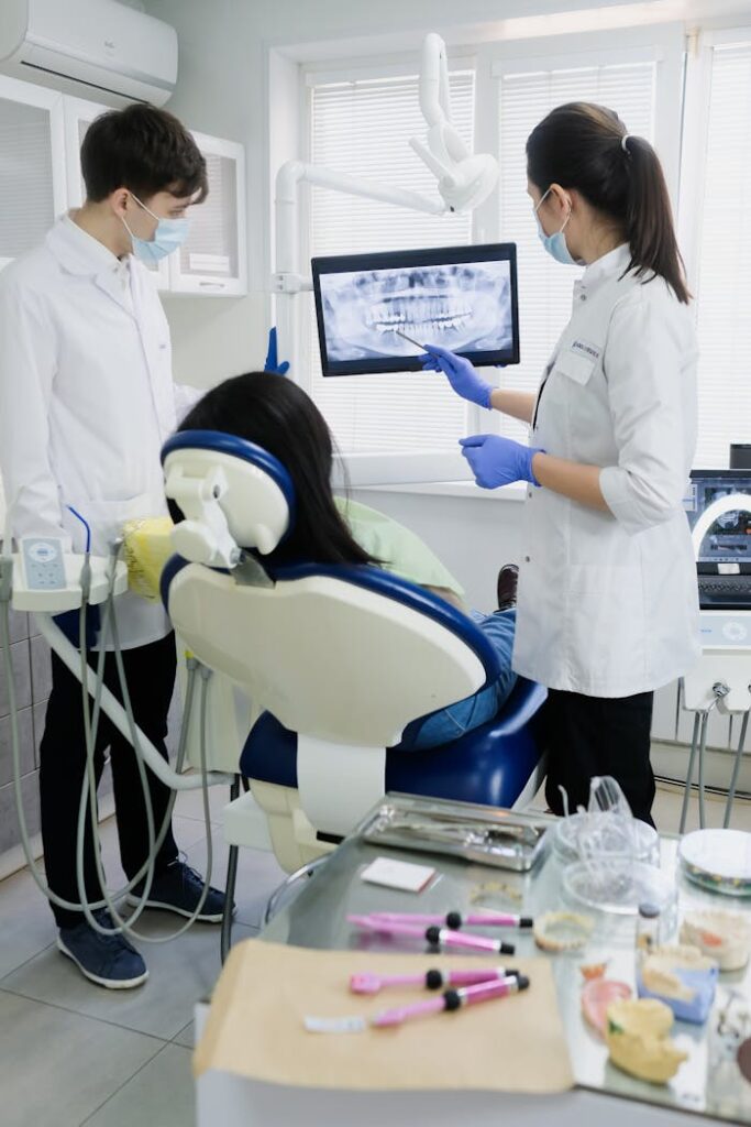 Dentists reviewing a dental X-ray for patient treatment in a modern clinic.